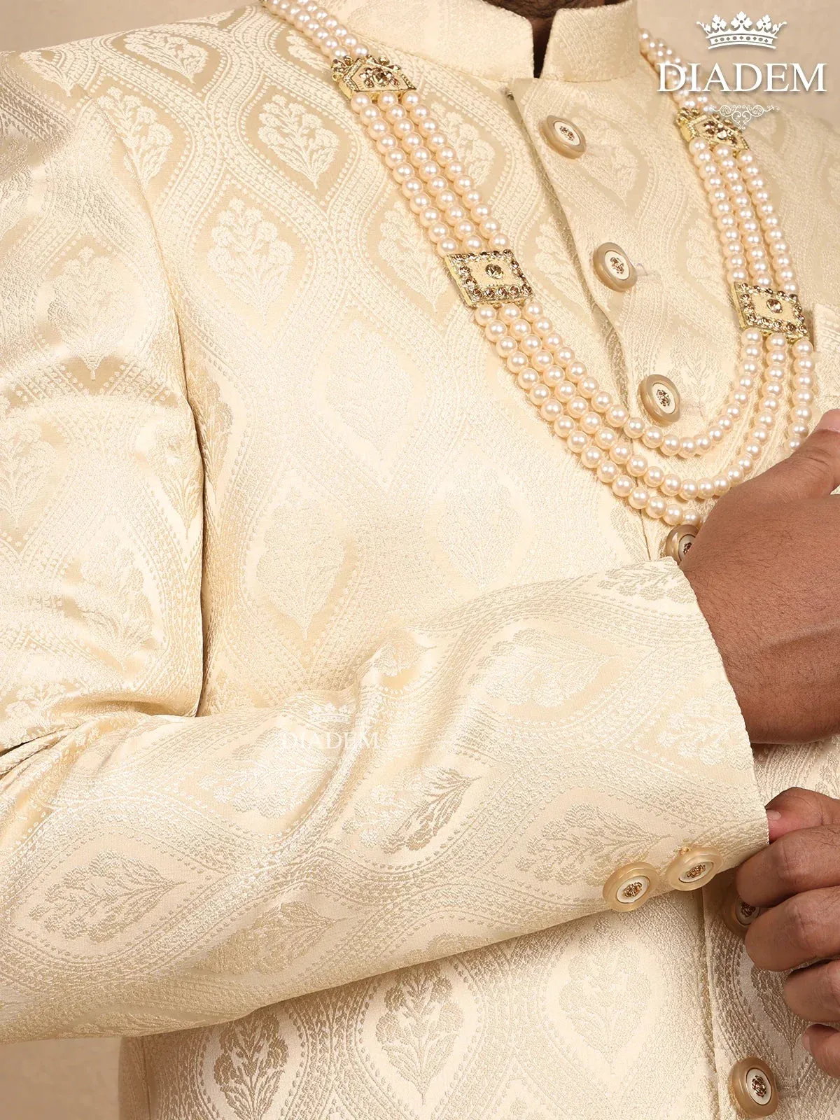 Cream Raw Silk Sherwani Suit Adorned with Floral Embroidery, Paired with Brooch and Bead Mala